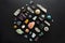Flat lay of various crystal stones set on black background. Gemstones on dark background. Colorful healing minerals for