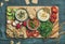 Flat-lay of Vegetarian dips hummus, babaganush, muhammara on wooden board