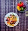 Flat lay: vegetarian spaghetti with fried colorful vegetables and grated hard cheese