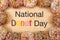 Flat lay view border of many frosted donuts with National Donut Day text