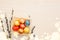 Flat lay view of colorful gold leaf colored Easter eggs in wood shred nest with pussy willow branches for decoration-