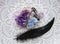 Flat lay view of various crystal geodes amethyst  celestite. With black glowing bird feather.
