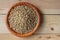 Flat lay view of a wooden bowl full of malted barley