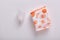 Flat lay of white menstrual cup and couple of packed hygiene pads being isolated over white background. Menstrual cap being eco