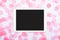 Flat lay of white touchpad with blank screen on pink confetti background