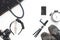 Flat lay of woman accessories with cellphone and black color items on white background