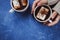 Flat lay of woman`s hands in sweater and two cups of cocoa or hot chocolate