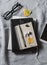 Flat lay women`s desk with tablet, notepad, phone, glasses, headphones. On a gray background, top view.