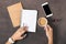 Flat lay women workspace female hands, coffee, notebook, smartphone, lipstick