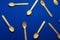 flat lay wooden spoons pattern on a blue background