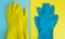 Flat lay yellow and blue rubber protective gloves on double table background for spring or daily cleaning. The concept commercial