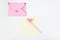 Flat lay: yellow paper, pink envelope with rhinestones, pen with pompom. Making postcard in envelope for Valentine`s Day. Do it