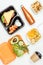 flat lay of yummy lunch and fruits in lunch boxes