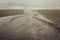 A Flat Meandering River leads down the Beach