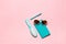 Flat minimalistic feminine composition of turquoise accessory: hairbrush, glasses, diary and pen isolated on pink copy