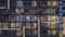 Flat night panorama of multicolor light in windows of multistory buildings aerial timelapse.