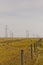 Flat prairie with metal and wood power towers