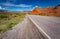 Flat road cuts through the desert area called red rocks of fire