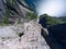 Flat rock Preikestolen over fjord Lysefjorden is natural attraction. Top view and flight up above cliff. Preacher`s Pulpit or Pre