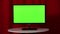 Flat screen TV. Standing on a white table. Green screen. Approved. Stamp. Red background.