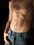 Flat sporty male belly on dark background