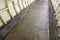 Flat stone floor and heavy iron plating on Thames under water tunnel wall.
