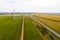 Flat terrain with lots of wind turbines in the fields and a highway stretching into the distance. The view from the top.