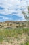 Flat topped plateau hill in the rural village of Ghasri, Gozo, Malta, with the Ta Giordan lighthou