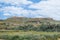 Flat topped plateau hill in the rural village of Ghasri, Gozo, Malta, with the Ta Giordan lighthou