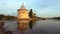 A flat tower with a reflection, July evening. Pskov, Russia