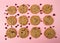 Flat view oatmeal cranberry cookies on pink