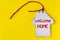 Flat vintage white wooden house with a pipe, a red rope and the inscription welcome home on a bright yellow background