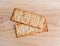 Flatbread salted multigrain crackers on a cutting board.