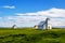 Flateyjarkirkja church and couple of living houses with meadow i