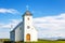 Flateyjarkirkja white lutheran church with meadow in foreground