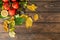 Flatlay autumn composition. Tomato, lemon, autumn fallen leaves on wooden desk. Flat lay, top view, copy space. Agriculture