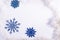 Flatlay blue christmas snowflakes on a white background. Copy space, new year minimalistic concept