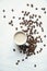 Flatlay coffee cup and coffee beans on a white background