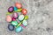 Flatlay, colorful dyed easter eggs and spoons on grey background, copyspace