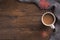 Flatlay composition with white knitted scarf, cup of coffe, on wooden desk table