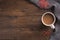 Flatlay composition with white knitted scarf, cup of coffe, on wooden desk table