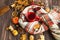 Flatlay of cozy fall setting. Scarf with tea cup and autumn decorations with pumpkins, dried leaves, pine cones