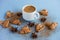 Flatlay of cup of coffee with brown cookies and star anise