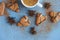 Flatlay of cup of coffee with brown cookies and star anise