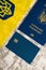 Flatlay, the flag of Ukraine with the coat of arms, a bank card and a passport of a citizen of Ukraine on a light gray