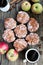 Flatlay of glazed apple fritter with fresh apples and hot coffee