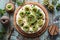 Flatlay of healthy raw gluten free dessert. Homemade tart with kiwi roses, berries, mint and cream filling on nutty crust served