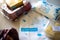 Flatlay image of multiple home essentials like milk, butter, fruits and bread coming from a milkbasket bag which