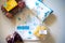 Flatlay image of multiple home essentials like milk, butter, fruits and bread coming from a milkbasket bag which