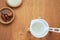 A flatlay overhead shot of the ingredients of water kefir or tibicos drink, including dried dates and organic raw cane sugar